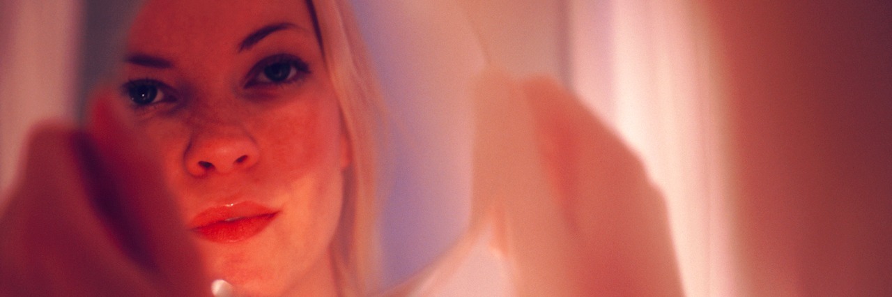 Figuring Out Your Identity With Borderline Personality Disorder a woman looking in the mirror