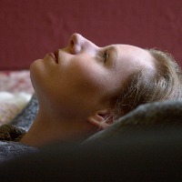 a woman looking up sitting on her couch