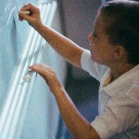 High angle view of a boy writing on a blackboard