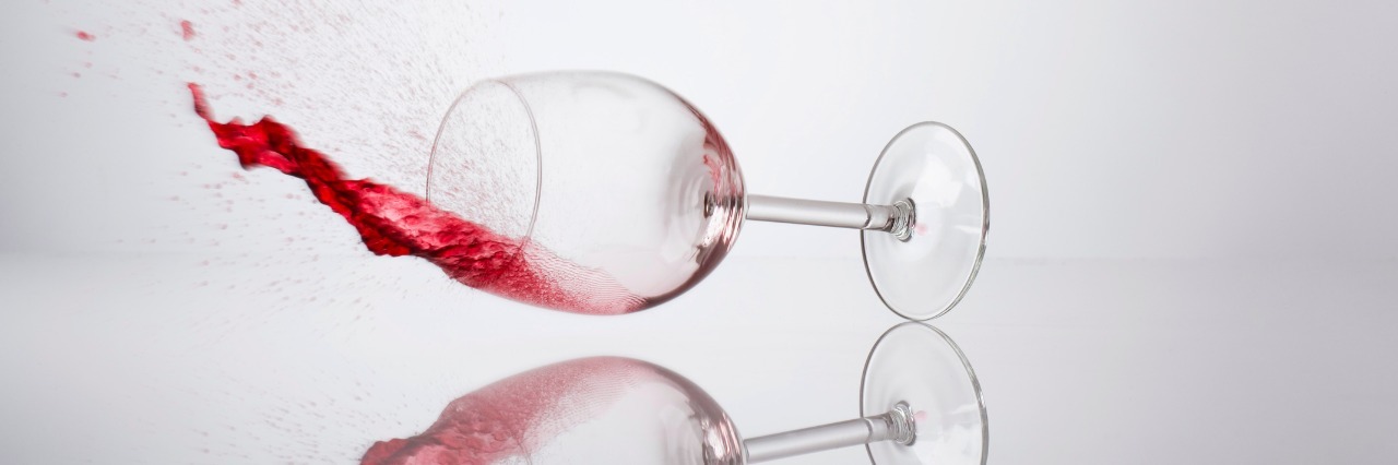 My Relationship With Alcohol: Am I an Alcoholic? glass of wine spilling