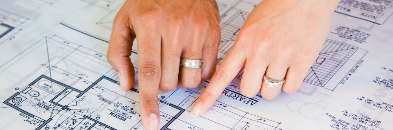 Day of Diagnosis: A Diagnosis Gives Us a Guidebook Couple pointing to blueprints