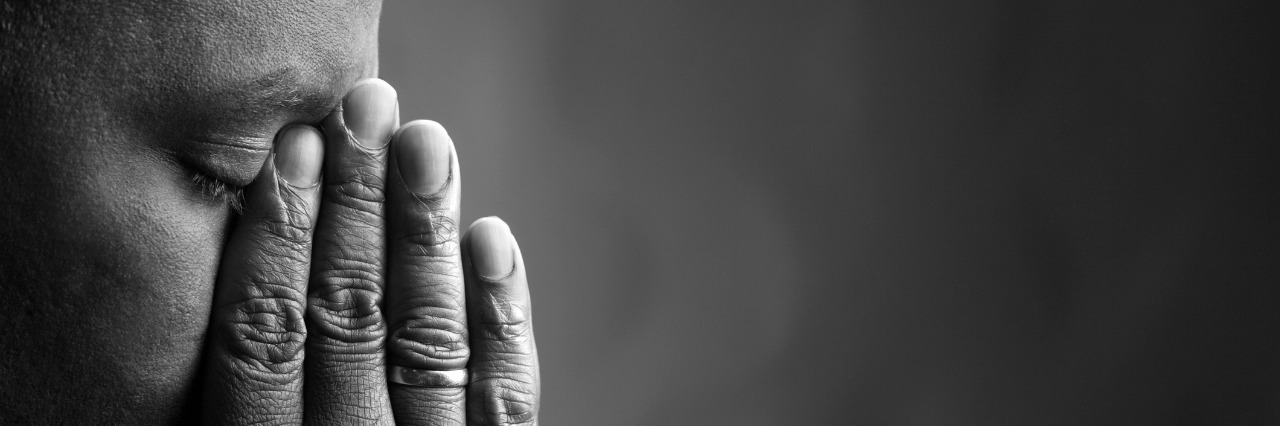 Chronic Pain Patient's Response to DEA Reduction of Opioids black and white photo of man holding hands over eyes and nose
