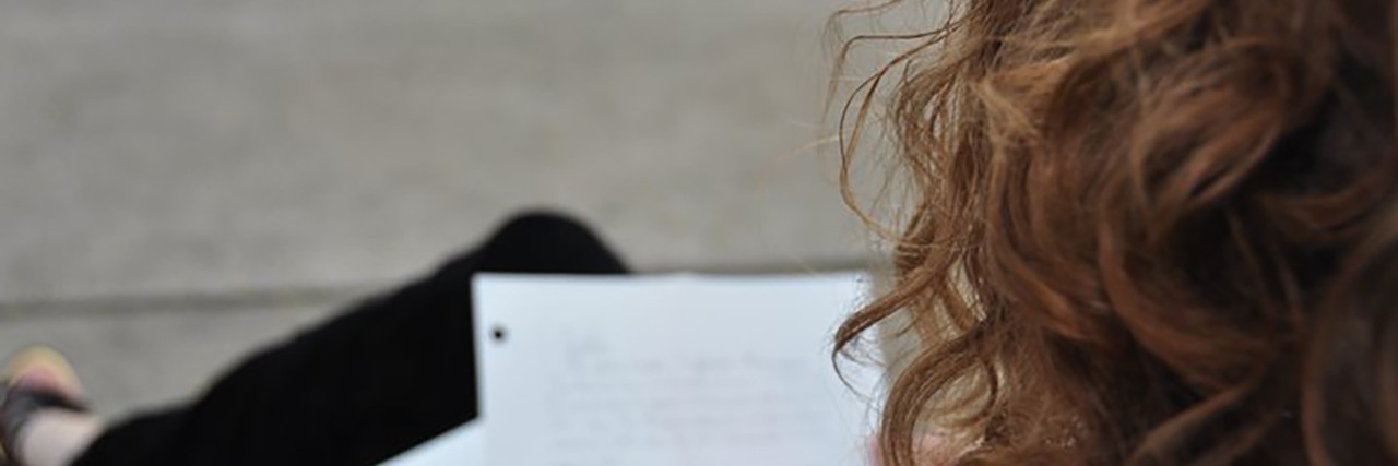 Letter to Teachers From a Student With Visual Impairment and Anxiety Emily reading a letter.