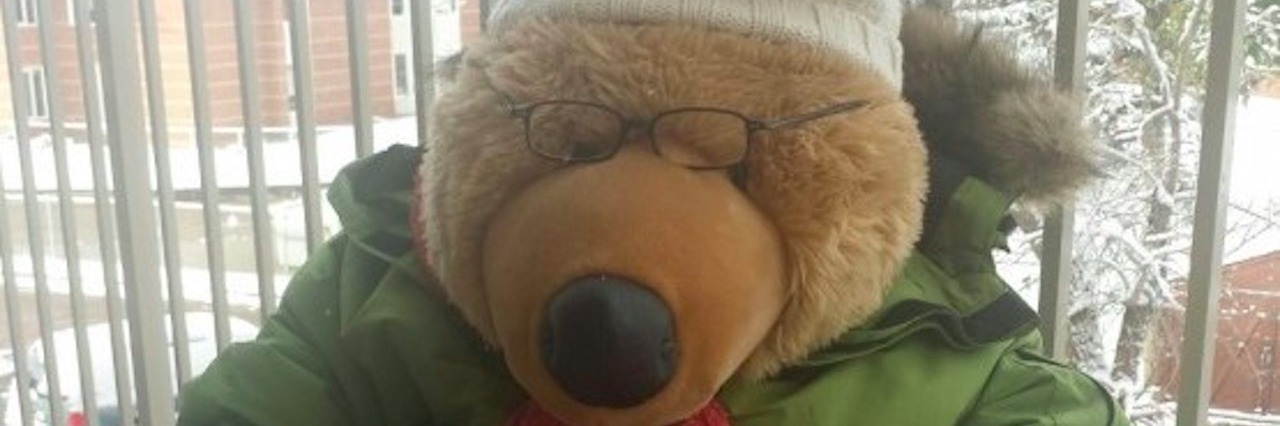 Why Winter and Snow Is Hard When You Have Chronic Fatigue stuffed bear wearing parka and scarf sitting on a chair outside in snow