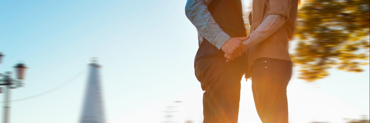 Dating as a Single Millennial with Lupus lovers kissing in the park at sunset in paris
