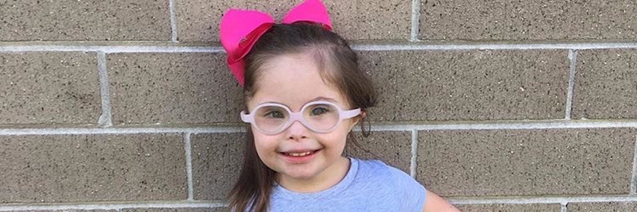 Mom Explains Importance of Down Syndrome Awareness Month little girl wearing a shirt that says kindness matters