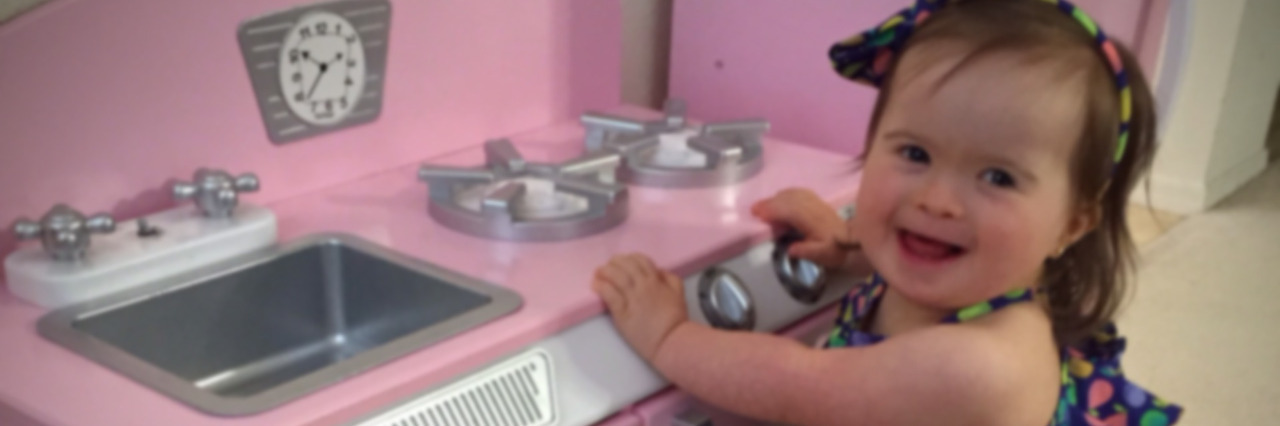 Down Syndrome and Doctors Who Push for Pregnancy Termination Maria's daughter playing in a pink child's kitchen.
