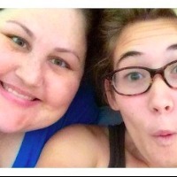 woman and teenage girl smiling and making silly face at camera