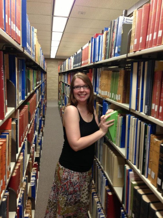 woman shelving books in the library