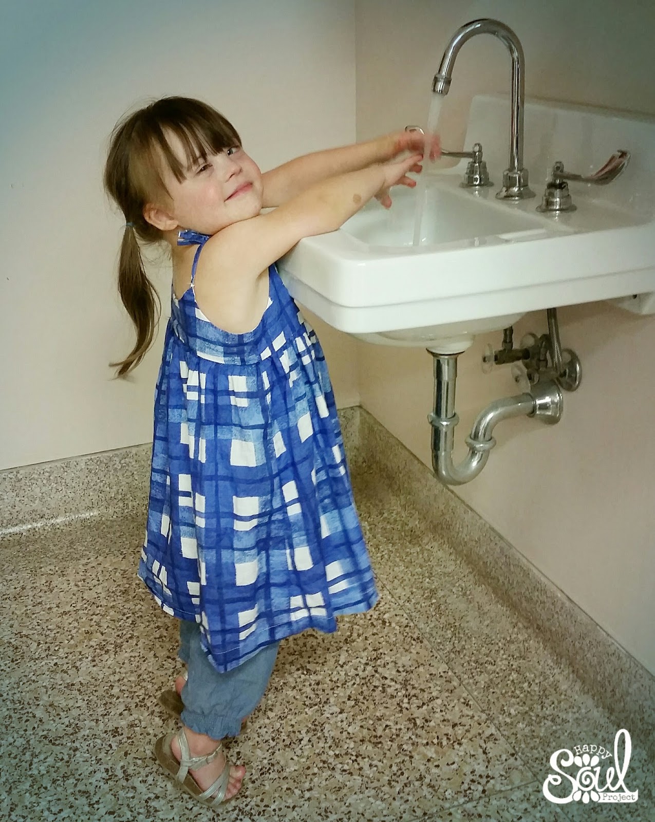 little girl washing her hands