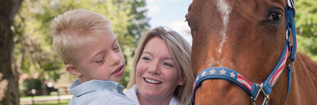 My Family Celebrates Down Syndrome Awareness Month Every Day Shawna and Gavin with a horse.