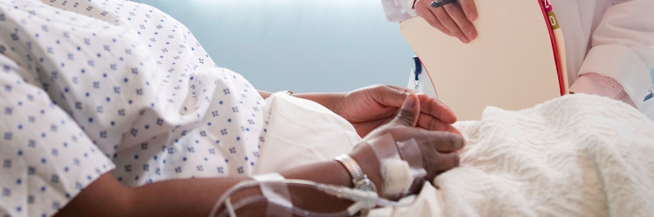 What It's Like Having an Undiagnosed Disease Female doctor talking to female patient lying in hospital bed
