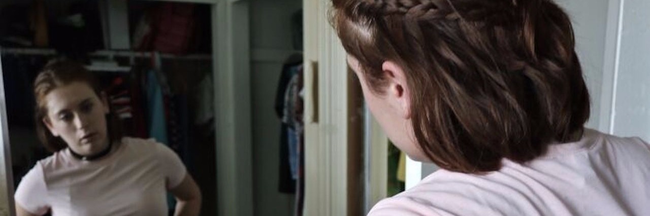 Highs, Mediums and Lows of College in Eating Disorder Recovery woman looking in the mirror