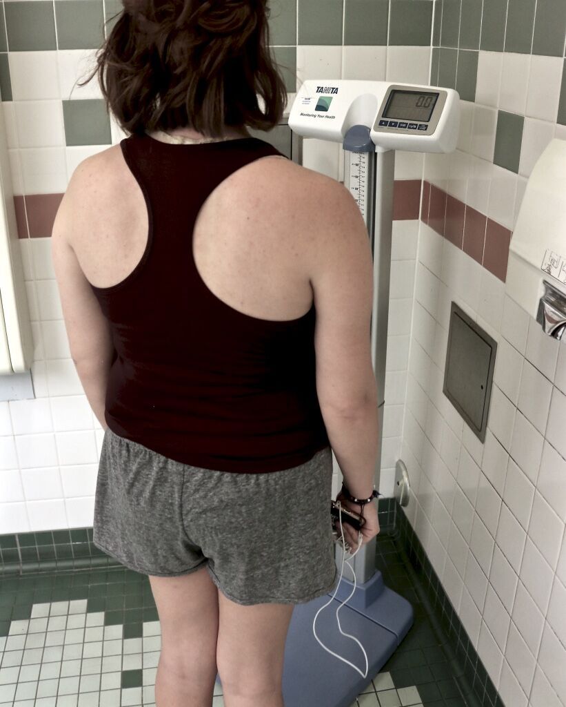 woman staring at a scale