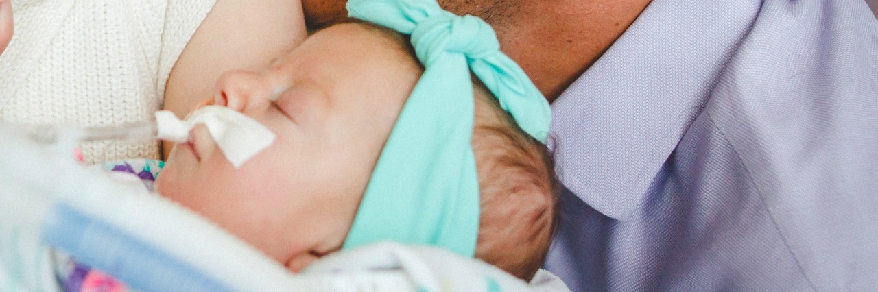 How to Deal With Grief After Losing a Child to Spinal Muscular Atrophy Whitney, her husband, and her daughter