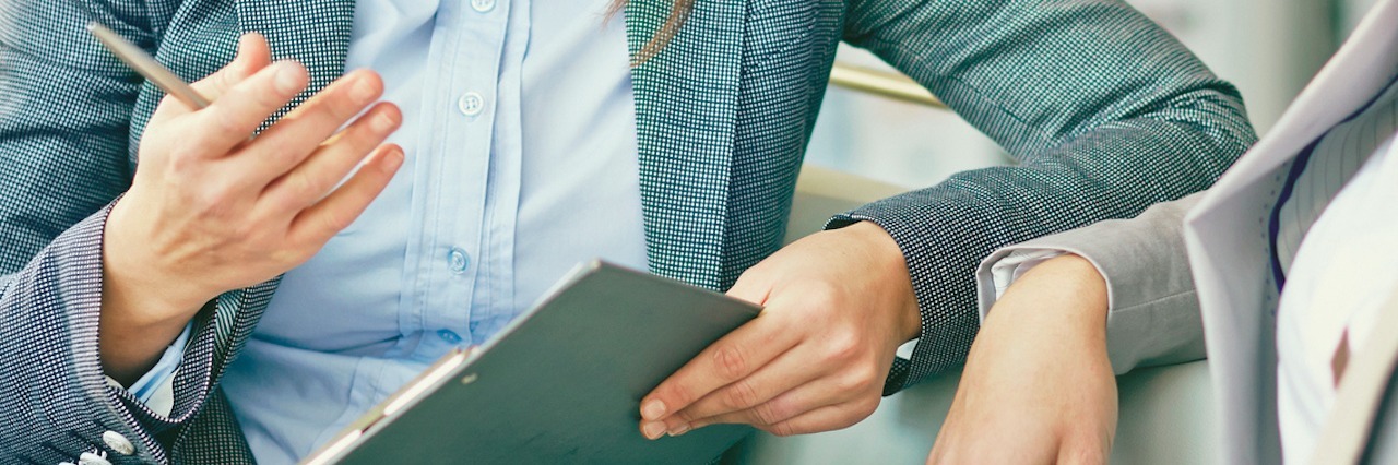 Why We Should Tell Employers We Have Fibromyalgia two women wearing business suits having a meeting