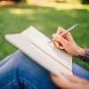 writing in a journal outside