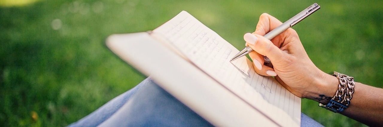 Writing as Therapy for Coping With Chronic Illness writing in a journal outside