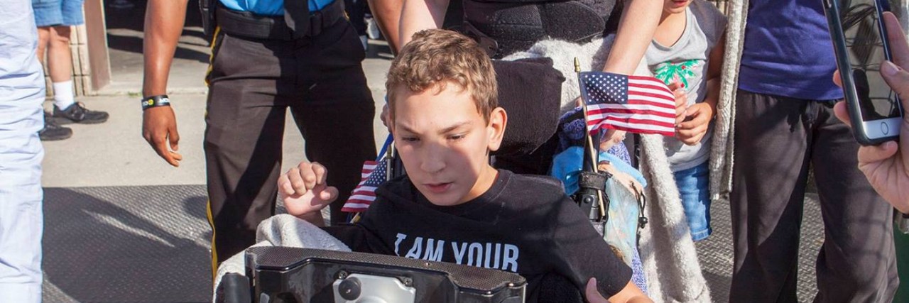 Donald Trump Kicks Kid With Cerebral Palsy Out of Campaign Rally J.J. Holmes and his mother being escorted out of rally.