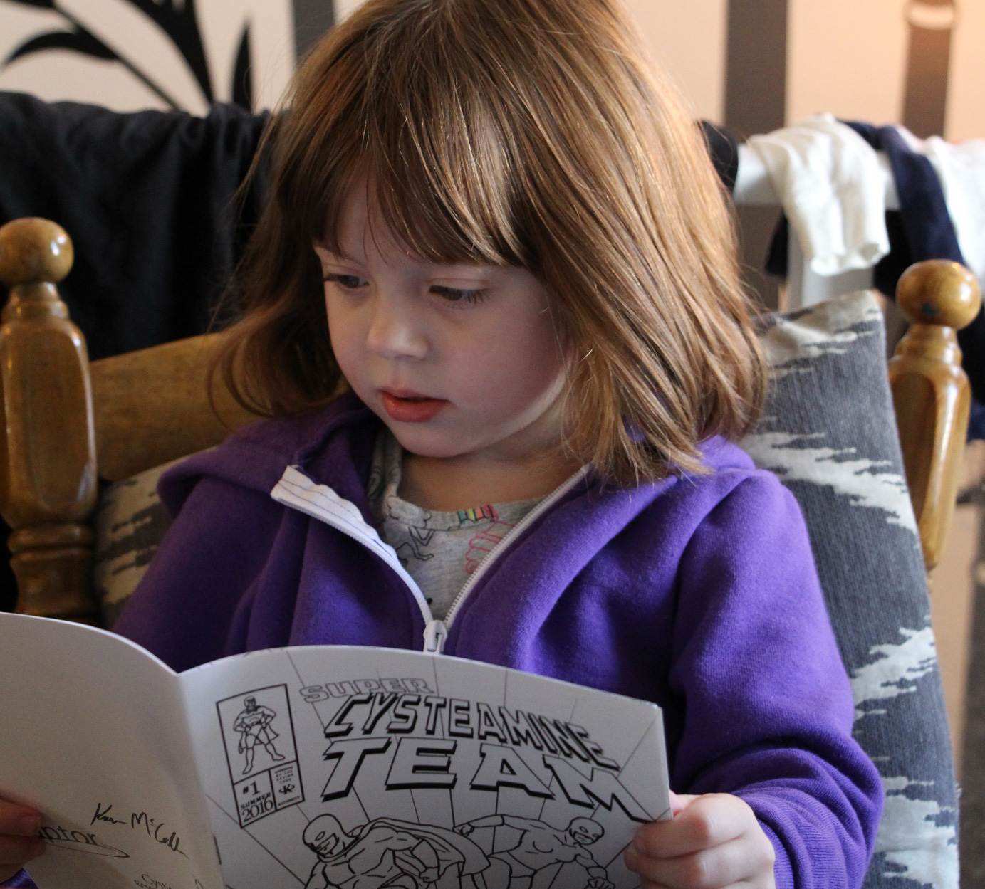 little girl reading comic book