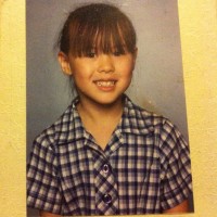 school photo of little girl with bangs and plaid shirt