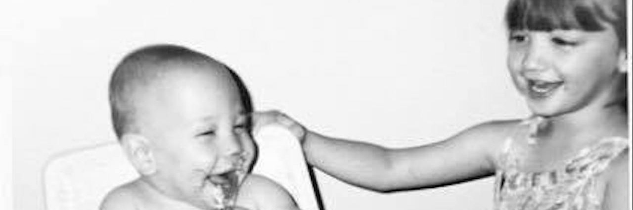 Finding a 'New Normal' After a Loved One's Suicide A small girl laughing with her toddler brother who is in a high chair