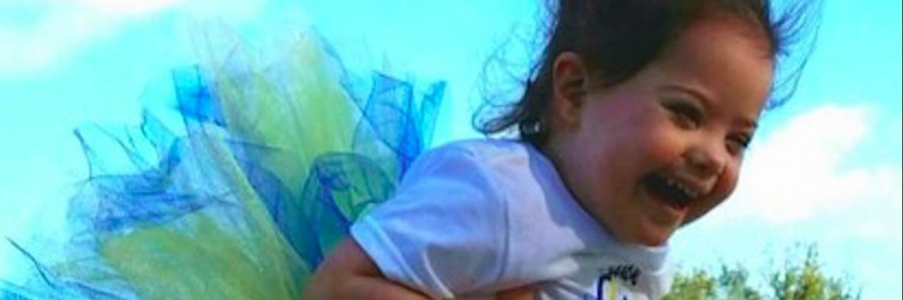 Mom Compares a Prenatal Down Syndrome Diagnosis to Skydiving child being lifted into the air