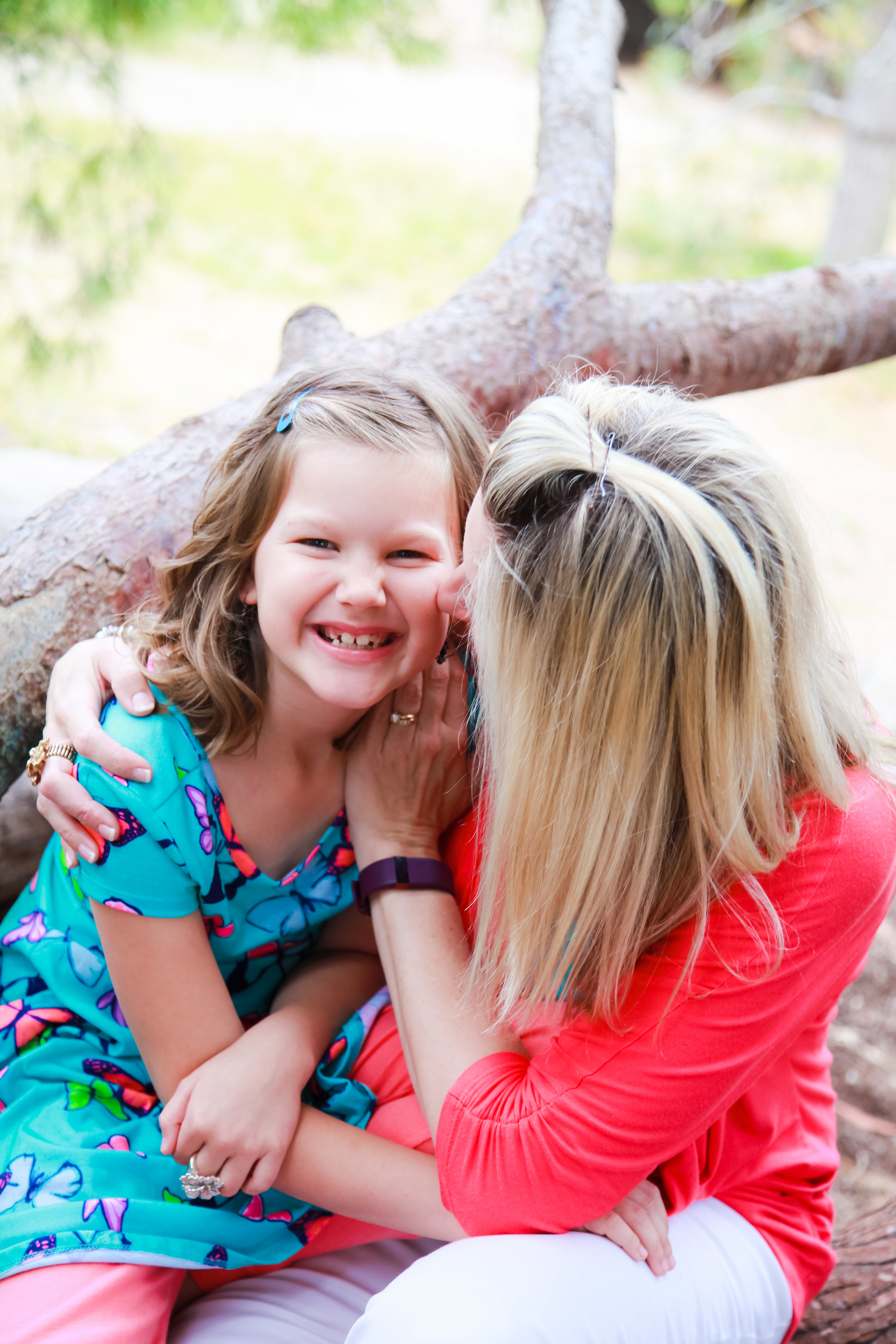 Mom and daughter kissing