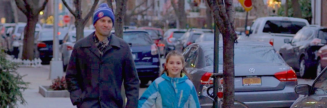 Trying to 'Cure' Your Child's OCD Man walking while holding daughter's hand on city sidewalk