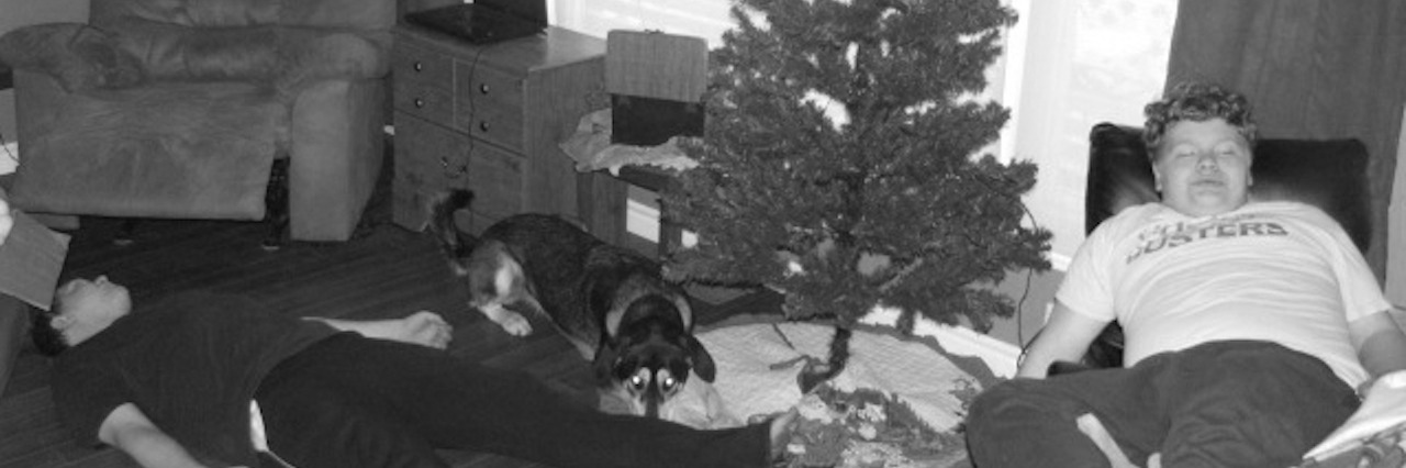 Remember Those With Chronic Illness During the Holidays two boys and a dog taking a nap in the living room by the christmas tree