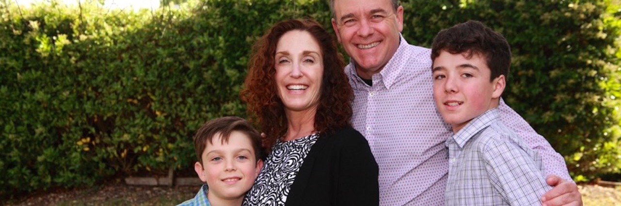 Special Needs Parenting: Tips for Stress-Free Holidays a mother father and their two sons dressed up for the holidays