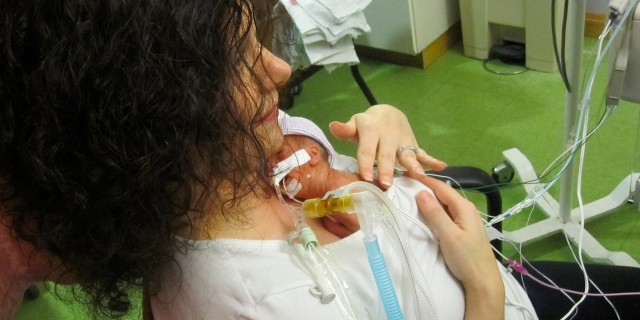 Mom holding her baby in the NICU