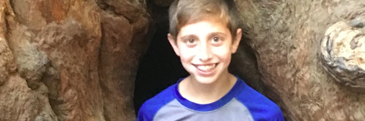 Ways I See the Bright Side of My Son's Chronic Illness boy standing near a rock formation
