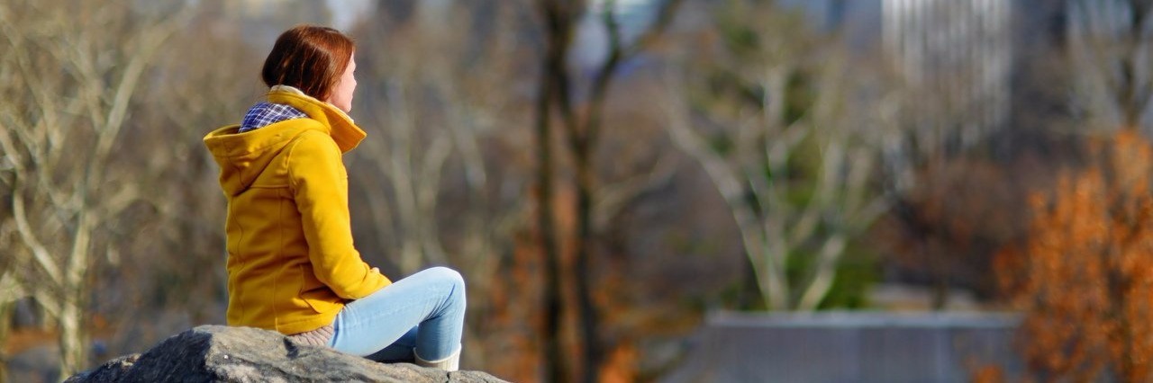 Why I'm Thankful for My Ehlers-Danlos Syndrome This Thanksgiving Young woman sitting on a rock in Central Park in New York City.