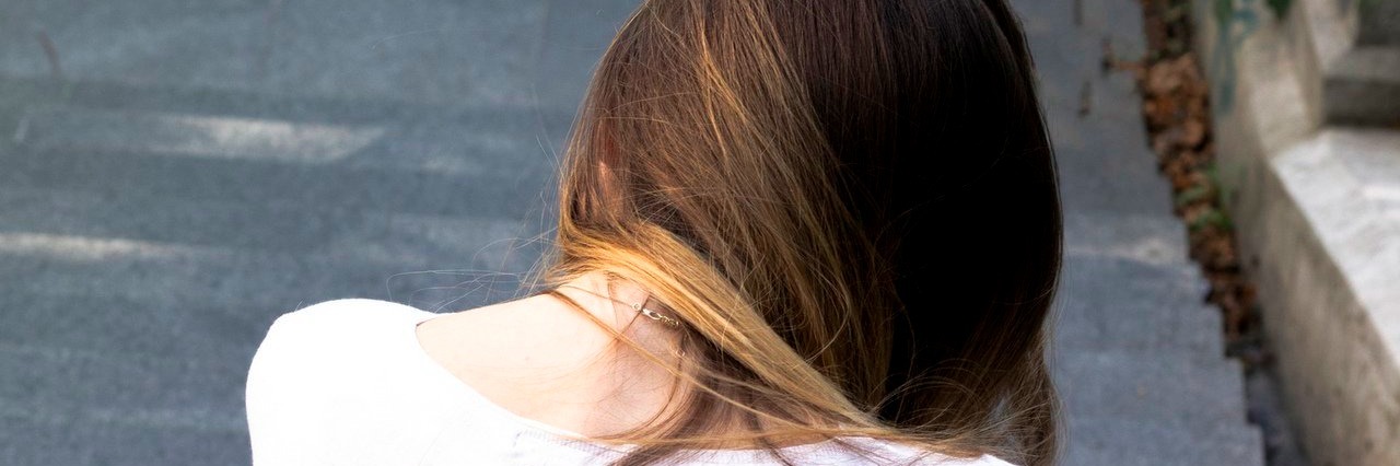 The ACA Matters to This Chronically Ill College Student young woman looking down