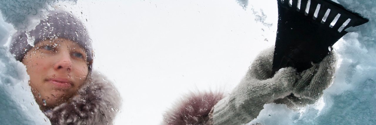 Tips I’ve Learned for Living With Chronic Pain in Winter woman cleaning snow-covered car with a scraper