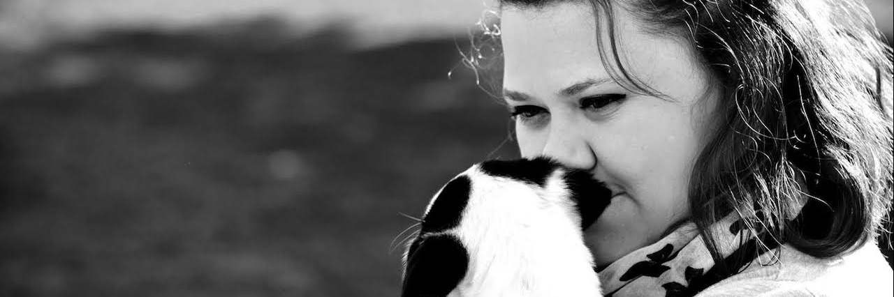 Major Depressive Disorder: When Fighting an Illness in Your Head A woman with her dog close to her face.