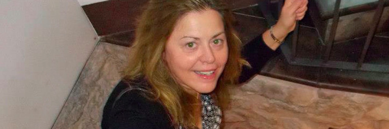 Traveling and Being a Writer With Connective Tissue Disease woman walking down steps