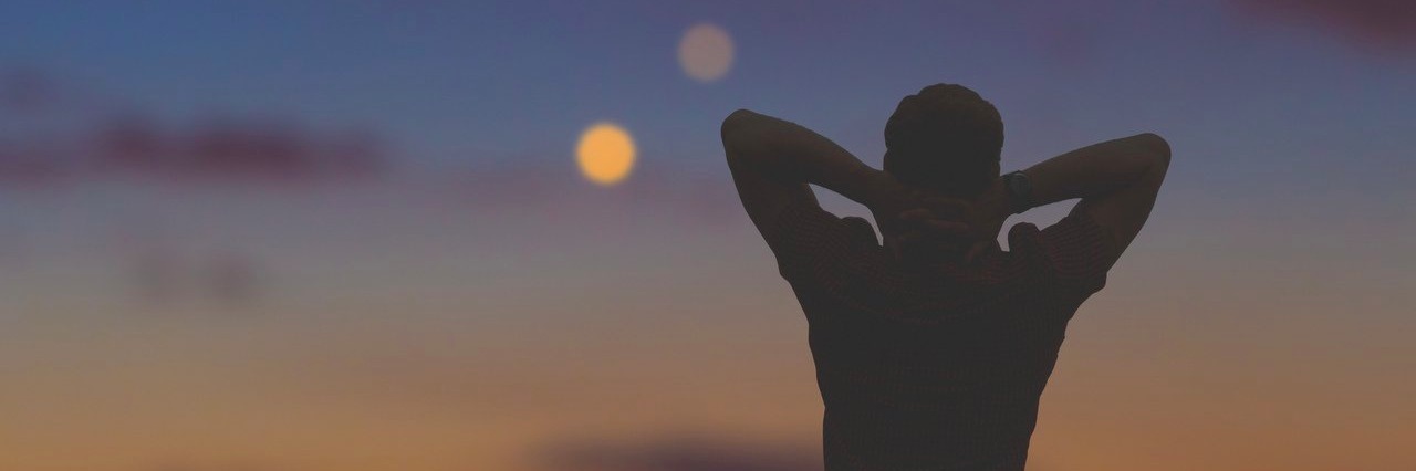 Elon Musk Dreams of Going to Mars. I Dream of Feeling Normal. man looking at the night sky and the city lights below