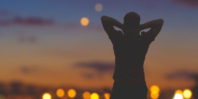 Elon Musk Dreams of Going to Mars. I Dream of Feeling Normal. man looking at the night sky and the city lights below