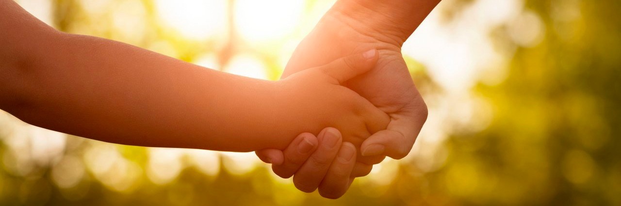 Mitochondrial Disease: Life With My Daughter Is About the Journey mother holding her daughter’s hand