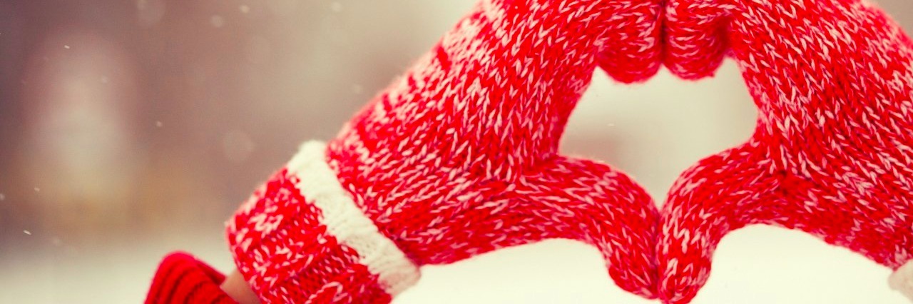 Ways to Support the Chronically Ill During the Holidays child forming a heart with her mittens