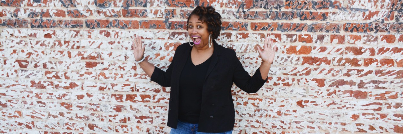 Feeling Guilt and Grief of Depression During the Holidays woman standing against a brick wall