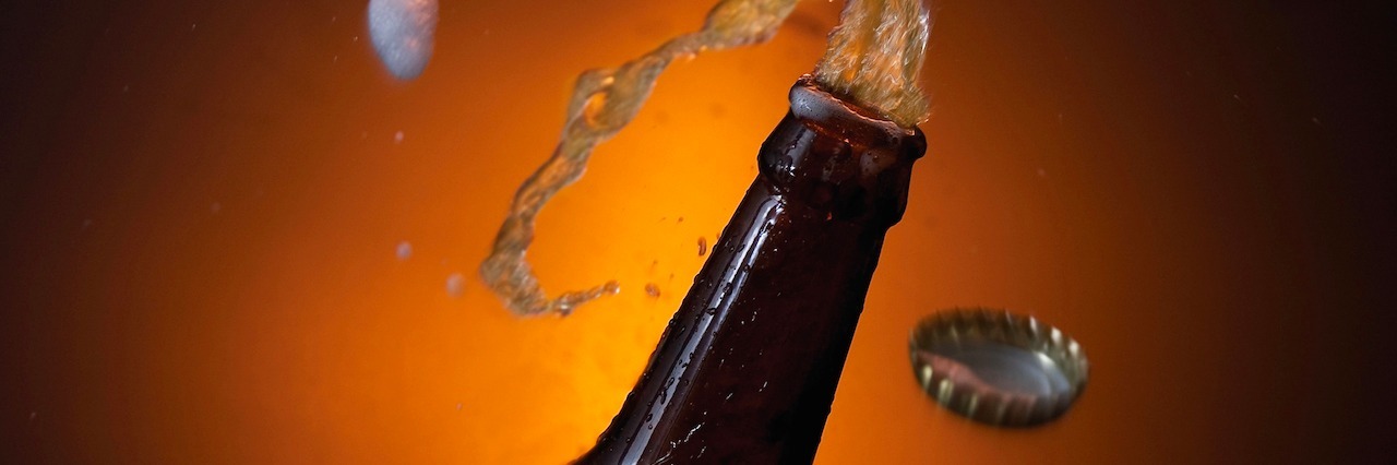 Challenges of Parenting a Child Who's an Addict or Alcoholic beer bottle with beer spilling out