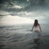woman standing in the ocean