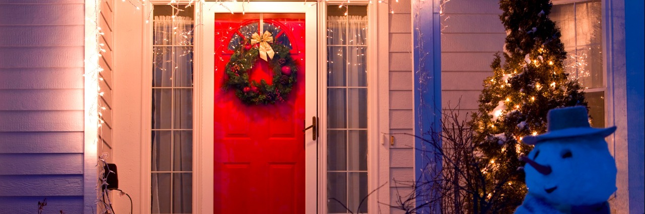 Having Ehlers-Danlos Syndrome When Family Is in Town the house front door decorated with Christmas wreath, lights and a snowman