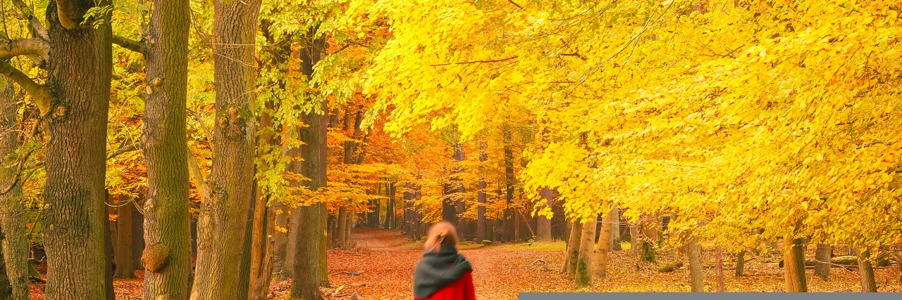 Woman walking in autumn park