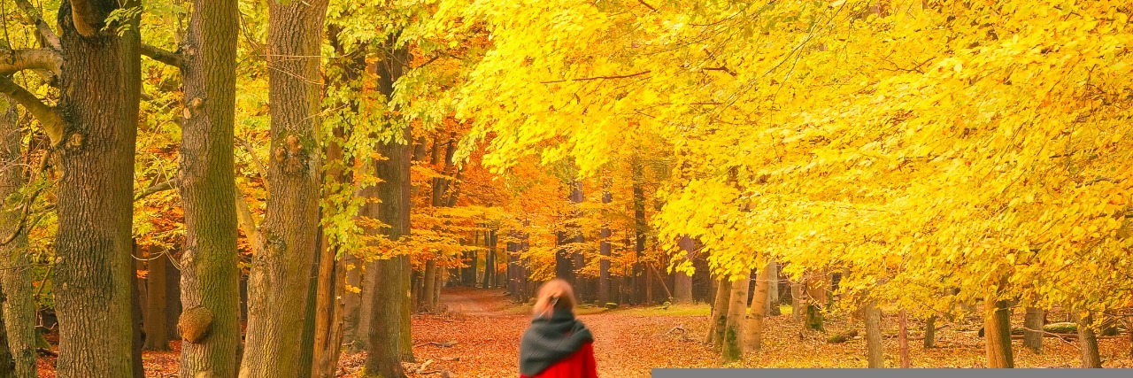 Understanding My Responses to Sensory Triggers Related to SPD Woman walking in autumn park