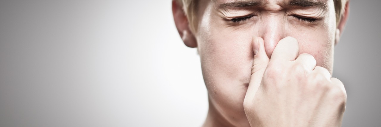 Learning How to Breathe to Help With Anxiety A young woman holding her breath.