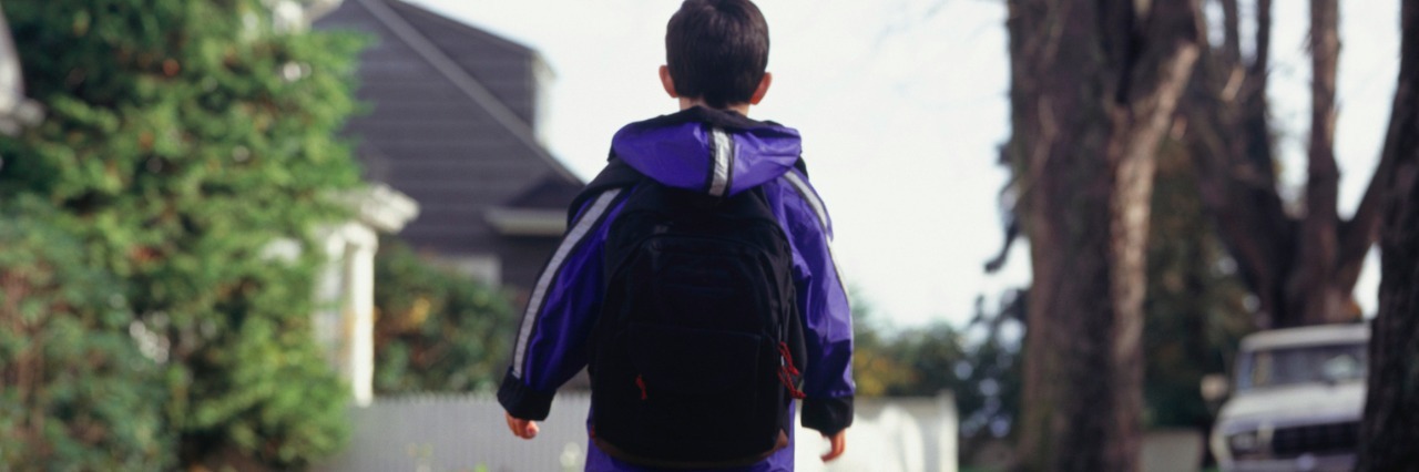 Things I’m Thankful for as a Parent of a Child on the Autism Spectrum Boy walking along leaf-covered path